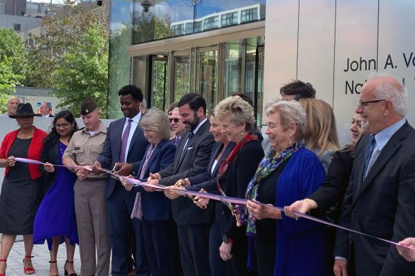 President Sally Kornbluth, fifth from left, joins Governor Maura Healey and members of the federal government and Cambridge community for a ribbon cutting at the new John A. Volpe National Transportation Systems Center.