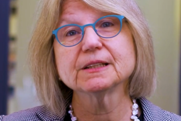 President Kornbluth stands on camera and shares a video message to the MIT community about government activity affecting MIT.