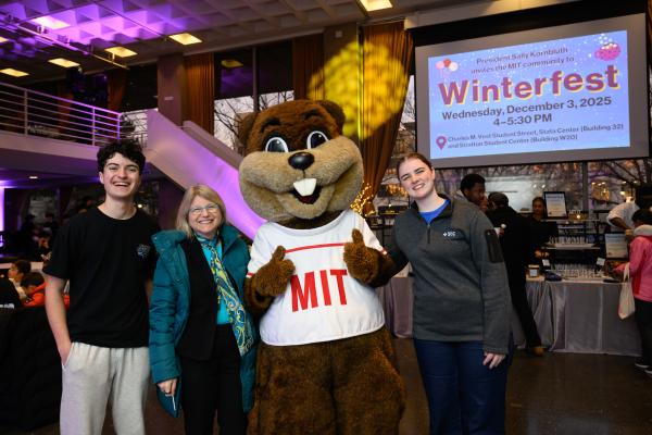 President Kornbluth poses with members of the community and Tim the Beaver.