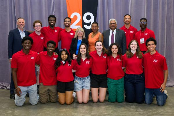 President Kornbluth stands in the back row, center, with leadership and MIT students.