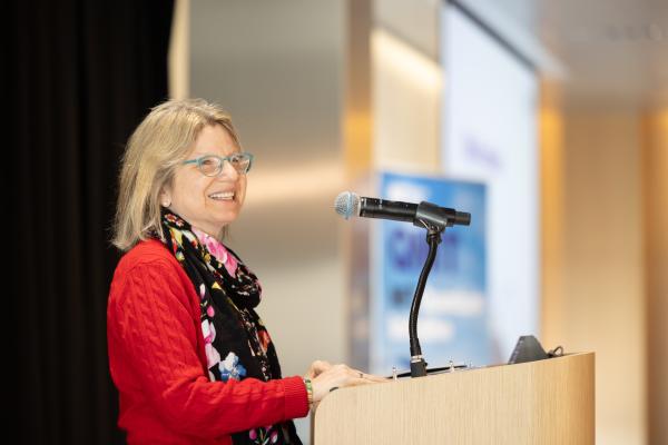 President Kornbluth speaks at podium.