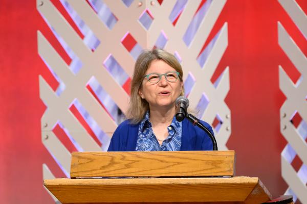 President Kornbluth stands behind the podium and speaks at Delta Day.