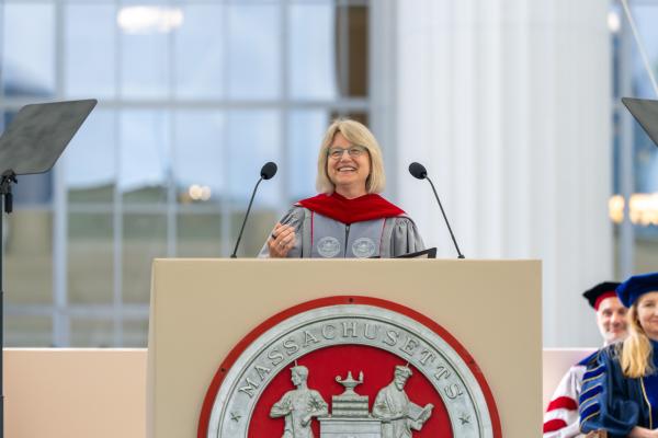 President Kornbluth at a podium delivering her charge to graduates at the One MIT Ceremony.