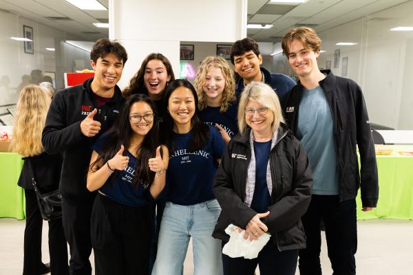 President Kornbluth on bottom right poses with a group of students during the May 5th Community Social.