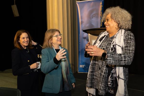 President Kornbluth shares a laugh standing between two colleagues in front of the podium during the 49th Dr. Martin Luther King, Jr. Celebration.